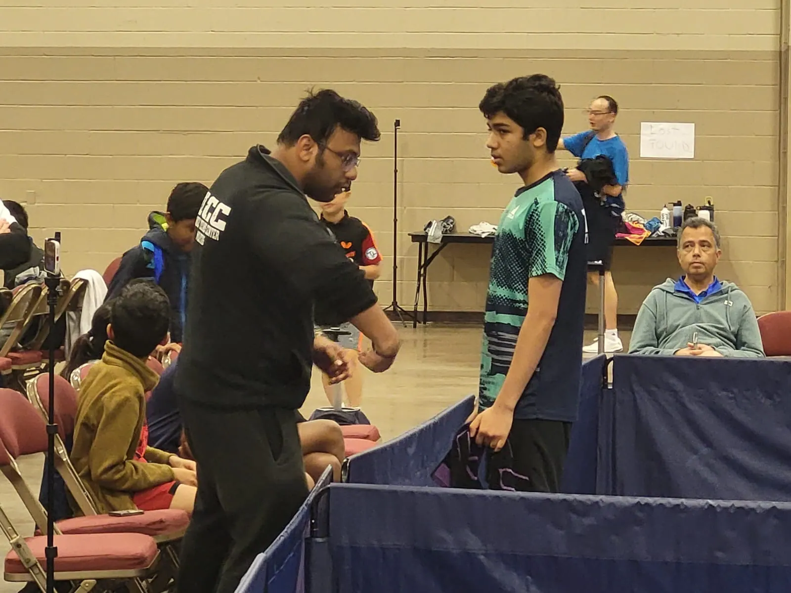 Subham Kundu talking tactics with Ved Sheth at the edge of a tournament court